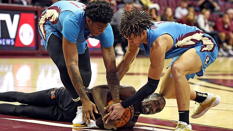 Nov 21, 2022; Tallahassee, Florida, USA; Mercer Bears guard Shawn Walker (25) fights for a loose ball with Florida State Seminoles guard Cam'Ron Fletcher (21) and guard Jalen Warley (1) during the first half at Donald L. Tucker Center. Mandatory Credit: Melina Myers-USA TODAY Sports