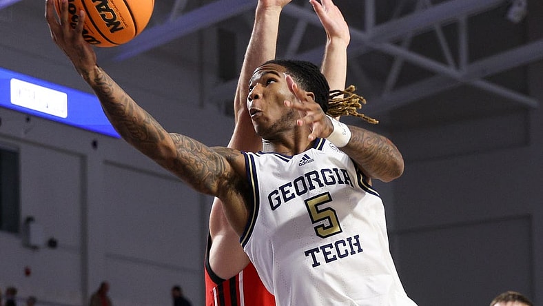 Nov 21, 2022; Fort Myers, Florida, USA;  Georgia Tech Yellow Jackets guard Deivon Smith (5) drives to the basket defended by Utah Utes guard Lazar Stefanovic (20) in the second half during the Fort Myers Tip-off at Suncoast Credit Union Arena. Mandatory Credit: Nathan Ray Seebeck-USA TODAY Sports
