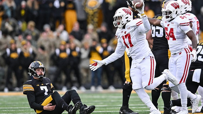 Nov 12, 2022; Iowa City, Iowa, USA; Wisconsin Badgers linebacker Darryl Peterson (17) and linebacker Jordan Turner (54) react as Iowa Hawkeyes quarterback Spencer Petras (7) looks on during the game at Kinnick Stadium. Mandatory Credit: Jeffrey Becker-USA TODAY Sports