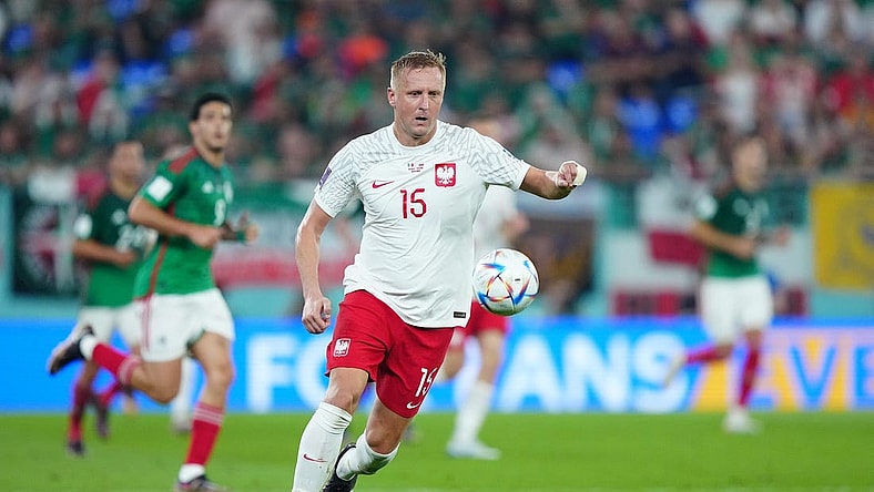 Nov 22, 2022; Doha, Qatar; Poland defender Kamil Glik (15) moves the ball during the second half against Mexico in a group stage match at the 2022 World Cup at Stadium 974. Mandatory Credit: Danielle Parhizkaran-USA TODAY Sports