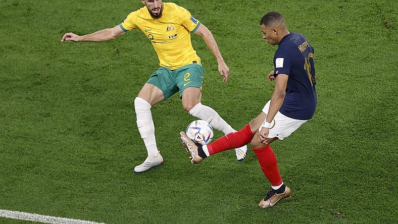 Nov 22, 2022; Al Wakrah, Qatar; France forward Kylian Mbappe (10) passes the ball while defended by Australia defender Milos Degenek (2) during the second half in a group stage match during the 2022 World Cup at Al Janoub Stadium. Mandatory Credit: Yukihito Taguchi-USA TODAY Sports