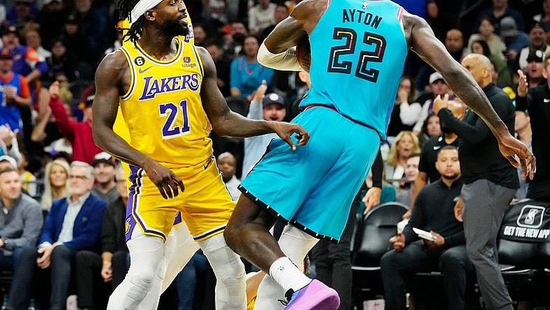 Nov 22, 2022; Phoenix, AZ, USA; Los Angeles Lakers guard Patrick Beverley (21) pushes Phoenix Suns center Deandre Ayton (22) to the court in the second half at Footprint Center. Beverley was ejected from the game. Mandatory Credit: Rob Schumacher-Arizona Republic