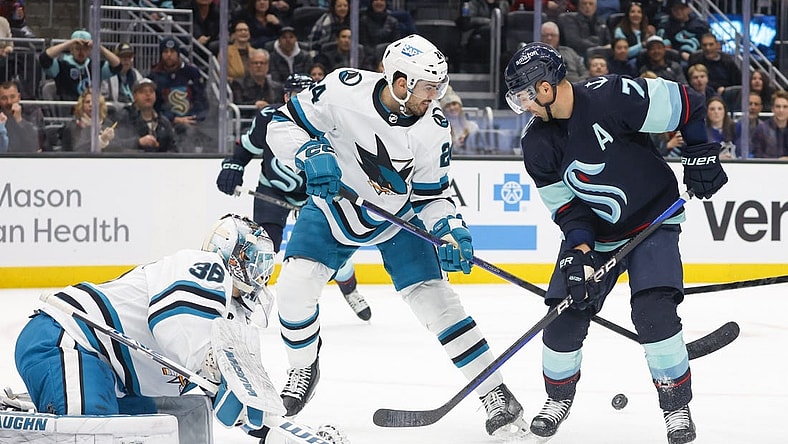 Nov 23, 2022; Seattle, Washington, USA; Seattle Kraken right wing Jordan Eberle (7) and San Jose Sharks defenseman Jaycob Megna (24) look for the puck following a save by goaltender Kaapo Kahkonen (36) during the first period at Climate Pledge Arena. Mandatory Credit: Joe Nicholson-USA TODAY Sports