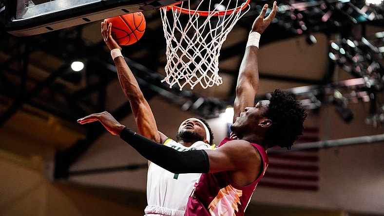 Nov 24, 2022; Orlando, FL, USA; Siena Saints guard Jared Billups (1) shoots as Florida State Seminoles center Naheem McLeod (24) attempts to block during the first half at ESPN Wide World of Sports. Mandatory Credit: Rich Storry-USA TODAY Sports
