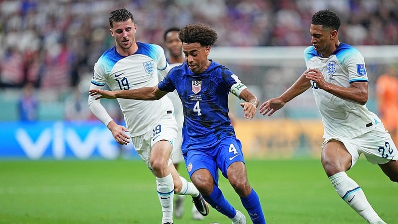 Nov 25, 2022; Al Khor, Qatar; United States of America midfielder Tyler Adams (4) dribbles the ball against England during the first half of a group stage match during the 2022 World Cup at Al Bayt Stadium. Mandatory Credit: Danielle Parhizkaran-USA TODAY Sports