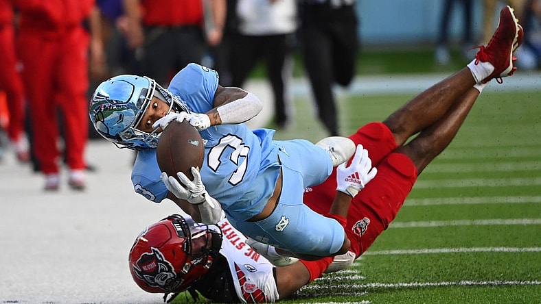 Nov 25, 2022; Chapel Hill, North Carolina, USA; North Carolina Tar Heels wide receiver Antoine Green (3) attempts to catch the ball as North Carolina State Wolfpack cornerback Aydan White (3) defends in the first quarter at Kenan Memorial Stadium. Mandatory Credit: Bob Donnan-USA TODAY Sports