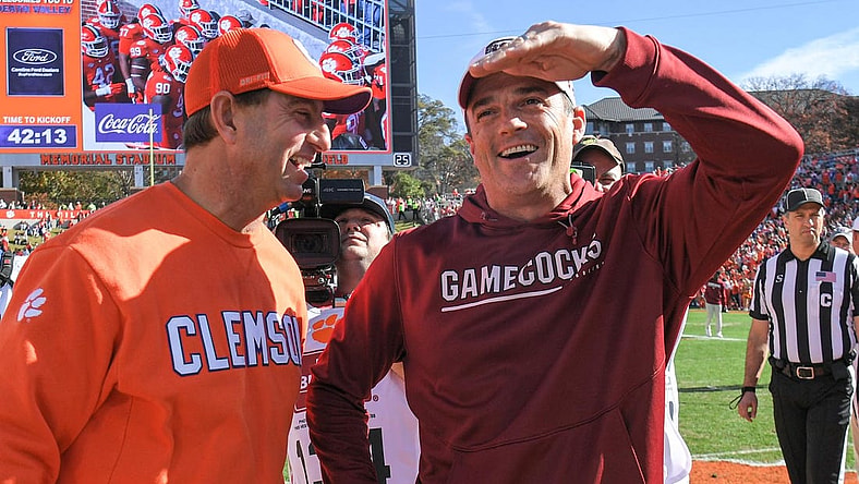 Nov 26, 2022; Clemson, SC, USA; Clemson head coach Dabo Swinney, left, and South Carolina head coach Shane Beamer talk before the game at Memorial Stadium in Clemson, S.C. Saturday, Nov. 26, 2022.    Mandatory Credit: Ken Ruinard-USA TODAY Sports