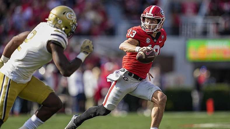 Nov 26, 2022; Athens, Georgia, USA; Georgia Bulldogs quarterback Stetson Bennett (13) runs with the ball against the Georgia Tech Yellow Jackets during the first quarter at Sanford Stadium. Mandatory Credit: Dale Zanine-USA TODAY Sports