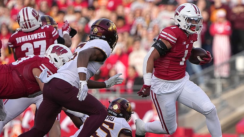 Nov 26, 2022; Madison, Wisconsin, USA; Wisconsin running back Chez Mellusi (1) runs for a first down during the first quarter of their game against Minnesota  at Camp Randall Stadium. Mandatory Credit: Mark Hoffman-USA TODAY Sports