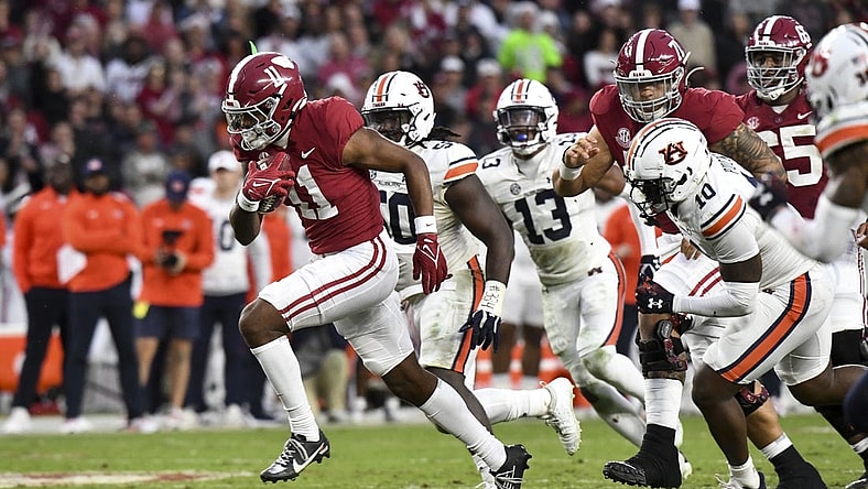 Nov 26, 2022; Tuscaloosa, Alabama, USA; Alabama wide receiver Traeshon Holden (11) breaks away from Auburn defenders including Auburn safety Zion Puckett (10) and Auburn defensive lineman Marcus Harris (50) on his way to a touchdown at Bryant-Denny Stadium. Mandatory Credit: Gary Cosby Jr.-USA TODAY Sports
