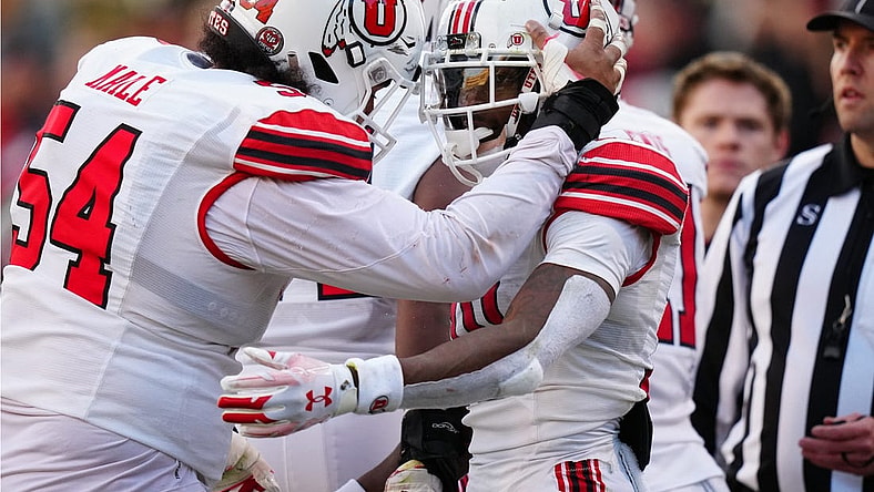 Nov 26, 2022; Boulder, Colorado, USA; Utah Utes wide receiver Money Parks (10) is congratulated for his touchdown by Utah Utes offensive lineman Paul Maile (54) in the second quarter at Folsom Field. Mandatory Credit: Ron Chenoy-USA TODAY Sports