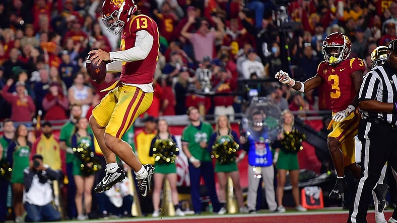 Nov 26, 2022; Los Angeles, California, USA; Southern California Trojans quarterback Caleb Williams (13) scores a touchdown against the Notre Dame Fighting Irish during the first half at the Los Angeles Memorial Coliseum. Mandatory Credit: Gary A. Vasquez-USA TODAY Sports