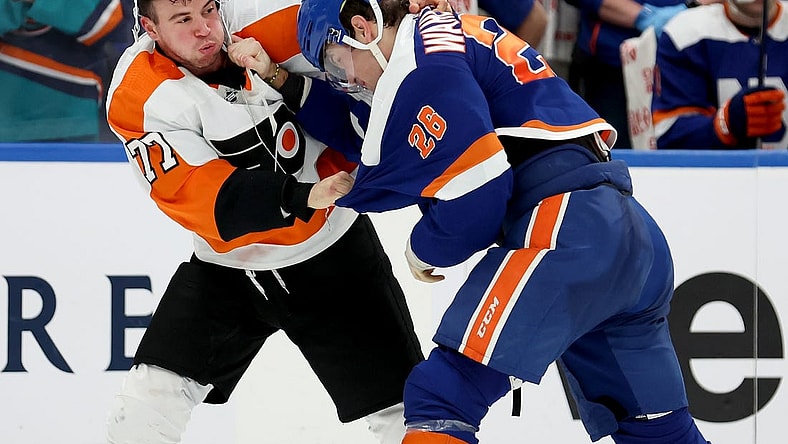 Nov 26, 2022; Elmont, New York, USA; Philadelphia Flyers defenseman Tony DeAngelo (77) fights New York Islanders right wing Oliver Wahlstrom (26) during the third period at UBS Arena. Mandatory Credit: Brad Penner-USA TODAY Sports