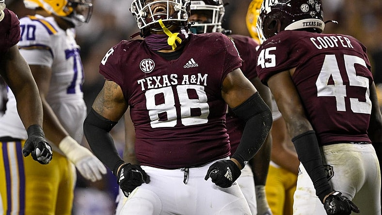 Nov 26, 2022; College Station, Texas, USA; Texas A&M Aggies defensive lineman Walter Nolen (88) and linebacker Edgerrin Cooper (45) celebrate a defensive stop against the LSU Tigers during the second half at Kyle Field. Mandatory Credit: Jerome Miron-USA TODAY Sports