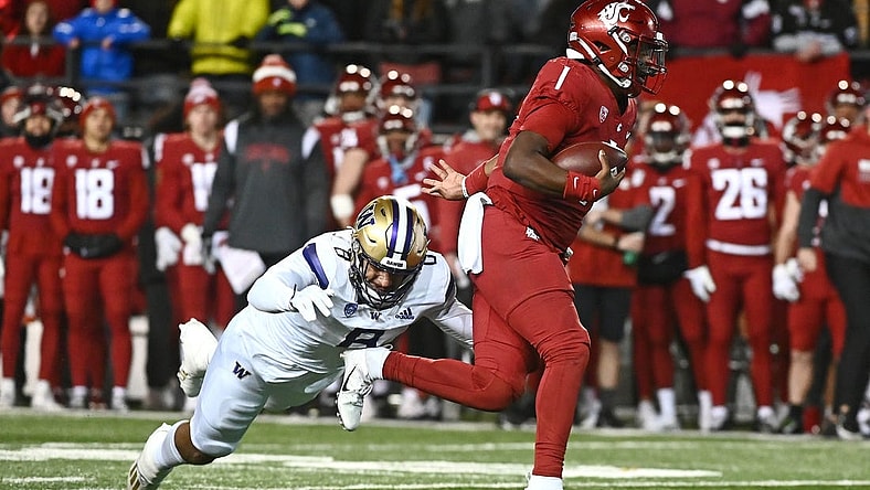 Nov 26, 2022; Pullman, Washington, USA; Washington State Cougars quarterback Cameron Ward (1) is caught from behind by Washington Huskies defensive lineman Bralen Trice (8) in first half at Gesa Field at Martin Stadium. Mandatory Credit: James Snook-USA TODAY Sports