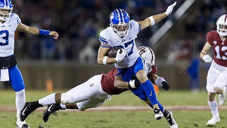 Nov 26, 2022; Stanford, California, USA;  Brigham Young Cougars wide receiver Chase Roberts (27) runs the ball against Stanford Cardinal defensive end Aeneas DiCosmo (0) during the first half at Stanford Stadium. Mandatory Credit: John Hefti-USA TODAY Sports