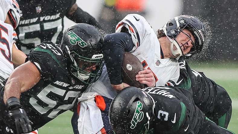 Nov 27, 2022; East Rutherford, New Jersey, USA; Chicago Bears quarterback Trevor Siemian (15) is tackled by New York Jets wide receiver Tarik Black (3) and defensive end Jermaine Johnson (52) during the first half at MetLife Stadium. Mandatory Credit: Vincent Carchietta-USA TODAY Sports