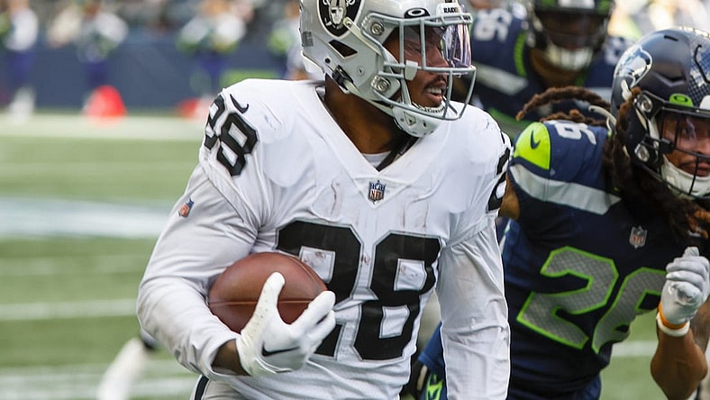 Nov 27, 2022; Seattle, Washington, USA; Las Vegas Raiders running back Josh Jacobs (28) rushes fora touchdown against the Seattle Seahawks during the second quarter at Lumen Field. Mandatory Credit: Joe Nicholson-USA TODAY Sports