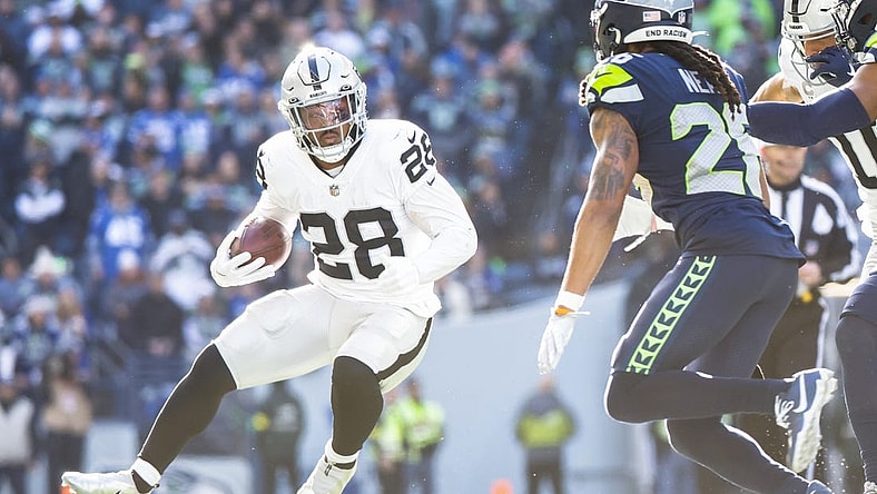 Nov 27, 2022; Seattle, Washington, USA; Las Vegas Raiders running back Josh Jacobs (28) rushes against the Seattle Seahawks during the first quarter at Lumen Field. Mandatory Credit: Joe Nicholson-USA TODAY Sports