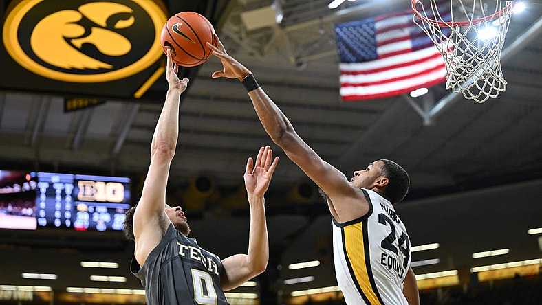 Nov 29, 2022; Iowa City, Iowa, USA; Iowa Hawkeyes forward Kris Murray (24) blocks the shot of Georgia Tech Yellow Jackets guard Lance Terry (0) during the first half at Carver-Hawkeye Arena. Mandatory Credit: Jeffrey Becker-USA TODAY Sports