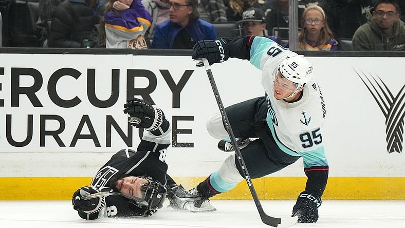 Nov 29, 2022; Los Angeles, California, USA; Seattle Kraken left wing Andre Burakovsky (95) collides with LA Kings defenseman Drew Doughty (8) in the third period at Crypto.com Arena. Mandatory Credit: Kirby Lee-USA TODAY Sports