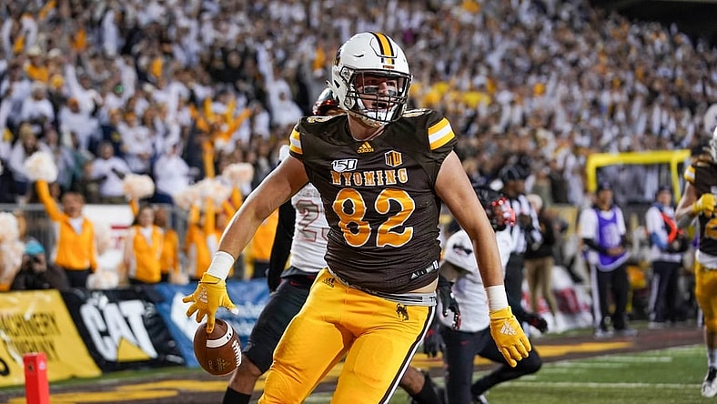 Sep 28, 2019; Laramie, WY, USA; Wyoming Cowboys tight end Jackson Marcotte (82) runs for a touchdown against UNLV Rebels defensive back Jericho Flowers (7) during the second quarter at Jonah Field War Memorial Stadium. Mandatory Credit: Troy Babbitt-USA TODAY Sports