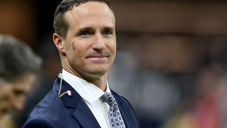Nov 25, 2021; New Orleans, Louisiana, USA; Former New Orleans Saints quarterback Drew Brees stands on the sidelines before the game between the New Orleans Saints and the Buffalo Bills at the Caesars Superdome. Brees is b being honored at half-time of the game that he is also announcing for NBC. Mandatory Credit: Chuck Cook-USA TODAY Sports