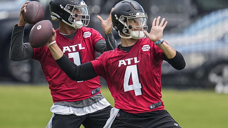 Jun 14, 2022; Flowery Branch, GA, USA; Atlanta Falcons quarterbacks Desmond Ridder (4) and Marcus Mariota (1) pass on the field during Minicamp at the Falcons Training Complex. Mandatory Credit: Dale Zanine-USA TODAY Sports