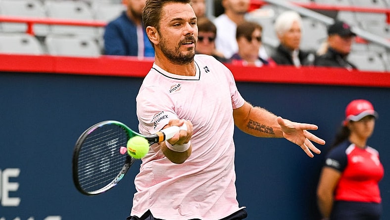 Aug 8, 2022; Montreal, Quebec, Canada; Stan Wawrinka (SUI) hits a shot against Emil Ruusuvuori (FIN) (not pictured) during first round play at IGA Stadium. Mandatory Credit: David Kirouac-USA TODAY Sports