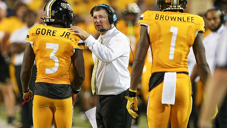 Sep 3, 2022; Hattiesburg, Mississippi, USA; Southern Miss Golden Eagles head coach Will Hall talks to running back Frank Gore Jr. (3) in the second half at M.M. Roberts Stadium. Liberty won in overtime, 29-27. Mandatory Credit: Chuck Cook-USA TODAY Sports