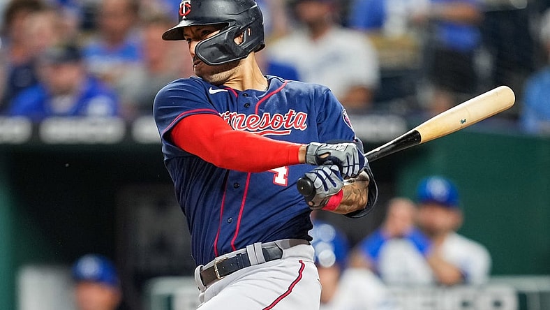 Sep 20, 2022; Kansas City, Missouri, USA; Minnesota Twins shortstop Carlos Correa (4) hits a two-run single against the Kansas City Royals during the second inning at Kauffman Stadium. Mandatory Credit: Jay Biggerstaff-USA TODAY Sports