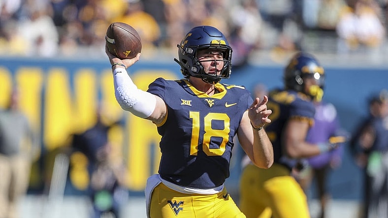 Oct 29, 2022; Morgantown, West Virginia, USA; West Virginia Mountaineers quarterback JT Daniels (18) throws a pass during the second quarter against the TCU Horned Frogs at Mountaineer Field at Milan Puskar Stadium. Mandatory Credit: Ben Queen-USA TODAY Sports
