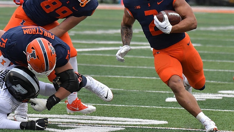 Nov 12, 2022; Champaign, Illinois, USA;  Illinois Fighting Illini running back Chase Brown (2) finds an opening in the Purdue Boilermakers defense during the first half at Memorial Stadium. Mandatory Credit: Ron Johnson-USA TODAY Sports
