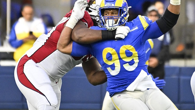 Nov 13, 2022; Inglewood, California, USA; Los Angeles Rams defensive tackle Aaron Donald (99) tries to slip past Arizona Cardinals guard Lecitus Smith (54) to get to quarterback Colt McCoy (not pictured) during the second quarter at SoFi Stadium. Mandatory Credit: Robert Hanashiro-USA TODAY Sports