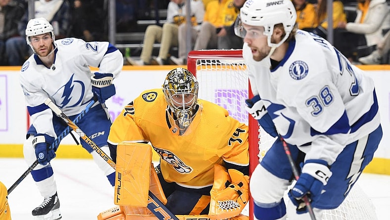 Nov 19, 2022; Nashville, Tennessee, USA; Nashville Predators goaltender Juuse Saros (74) watches as Tampa Bay Lightning left wing Brandon Hagel (38) handles the puck during the second period at Bridgestone Arena. Mandatory Credit: Christopher Hanewinckel-USA TODAY Sports