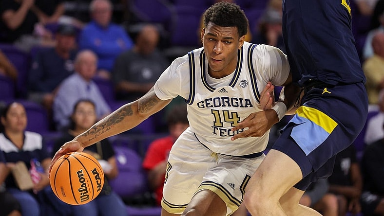 Nov 23, 2022; Fort Myers, Florida, USA;  Georgia Tech Yellow Jackets forward Jalon Moore (14) drives past Marquette Golden Eagles forward Ben Gold (21) in the second half during the Fort Myers Tip-Off Beach Division third place game at Suncoast Credit Union Arena. Mandatory Credit: Nathan Ray Seebeck-USA TODAY Sports