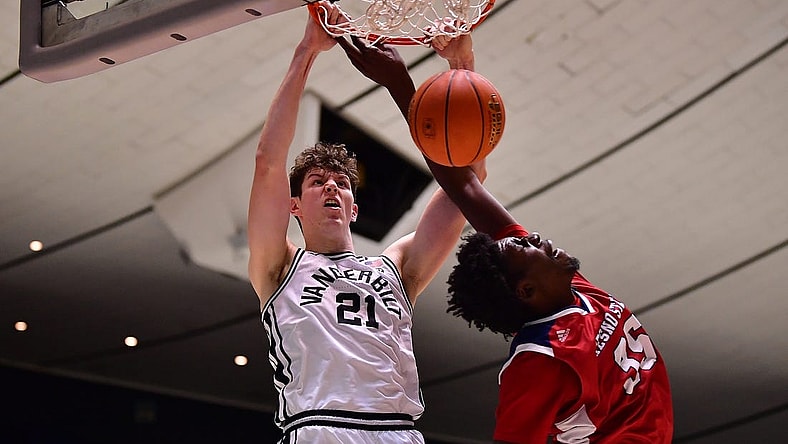 Nov 24, 2022; Anaheim, California, USA; Vanderbilt Commodores forward Liam Robbins (21) dunks for the basket against Fresno State Bulldogs center Eduardo Andre (35) during the second half at Anaheim Convention Center. Mandatory Credit: Gary A. Vasquez-USA TODAY Sports
