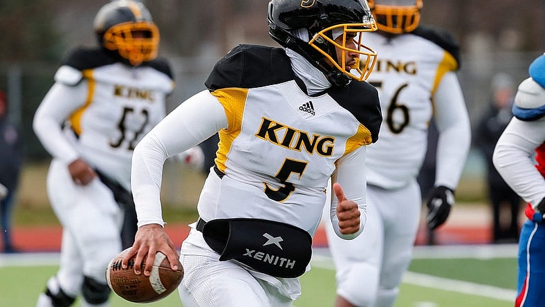 Detroit King quarterback Dante Moore (5) runs against Mason during the second half of Division 3 state semifinal at John Glenn High School in Westland on Saturday, Nov. 19, 2022.