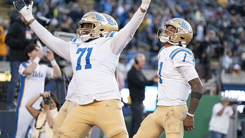 November 25, 2022; Berkeley, California, USA; UCLA Bruins offensive lineman Raiqwon O'Neal (71) and quarterback Dorian Thompson-Robinson (1) celebrate a two-point conversion against the California Golden Bears during the fourth quarter at California Memorial Stadium. Mandatory Credit: Kyle Terada-USA TODAY Sports