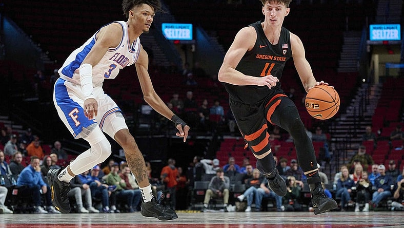 Nov 25, 2022; Portland, Oregon, USA;  Oregon State Beavers forward Dzmitry Ryuny (11) drives to the basket during the second half against Florida Gators forward Alex Fudge (3) at Moda Center. Florida won 81-68. Mandatory Credit: Troy Wayrynen-USA TODAY Sports