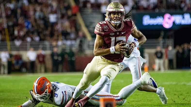 Florida State Seminoles quarterback Jordan Travis (13) eyes the end zone as he runs down the field. The Florida State Seminoles defeated the Florida Gators 45-38 at Doak Campbell Stadium on Friday, Nov. 25, 2022.

Fsu V Uf First Half1485