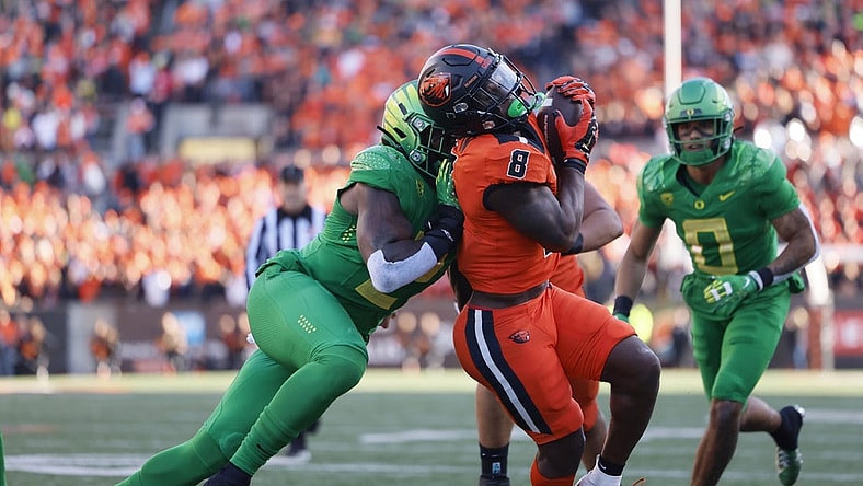 Nov 26, 2022; Corvallis, Oregon, USA; Oregon Ducks linebacker DJ Johnson (2) pushes Oregon State Beavers running back Jam Griffin (8) out of bounds during the first half at Reser Stadium. Mandatory Credit: Soobum Im-USA TODAY Sports