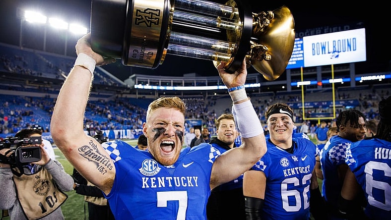 Nov 26, 2022; Lexington, Kentucky, USA; Kentucky Wildcats quarterback Will Levis (7) holds up the Governor   s Cup trophy after winning the game against the Louisville Cardinals at Kroger Field. Mandatory Credit: Jordan Prather-USA TODAY Sports
