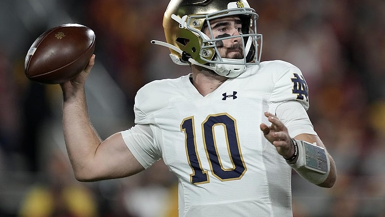 Nov 26, 2022; Los Angeles, California, USA; Notre Dame Fighting Irish quarterback Drew Pyne (10) throws the ball against the Southern California Trojans in the first half at United Airlines Field at Los Angeles Memorial Coliseum. Mandatory Credit: Kirby Lee-USA TODAY Sports