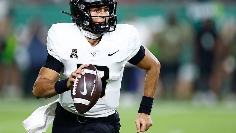 Nov 26, 2022; Tampa, Florida, USA; UCF Knights quarterback Mikey Keene (13) scrambles with the ball against the South Florida Bulls during the fourth quarter at Raymond James Stadium. Mandatory Credit: Douglas DeFelice-USA TODAY Sports