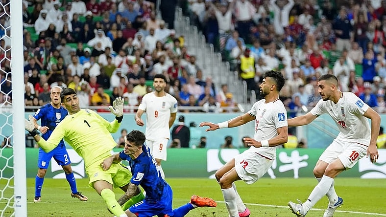 Nov 29, 2022; Doha, Qatar; United States of America forward Christian Pulisic (10) collides with Iran goalkeeper Alireza Beiranvand (1) after scoring a goal during the first half of a group stage during the 2022 World Cup at Al Thumama Stadium. Mandatory Credit: Danielle Parhizkaran-USA TODAY Sports