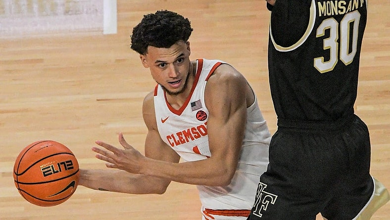 Dec 2, 2022; Clemson, SC, USA;  Clemson junior guard Chase Hunter (1) passes around Wake Forest guard Damari Monsanto (30) during the second half at Littlejohn Coliseum Friday, December 2, 2022. Mandatory Credit: Ken Ruinard/USA TODAY-USA TODAY NETWORK
