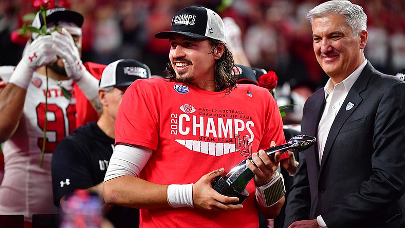 Dec 2, 2022; Las Vegas, NV, USA; Utah Utes quarterback Cameron Rising (7) celebrates after being named MVP in the victory against the Southern California Trojans in the PAC-12 Football Championship at Allegiant Stadium. Mandatory Credit: Gary A. Vasquez-USA TODAY Sports