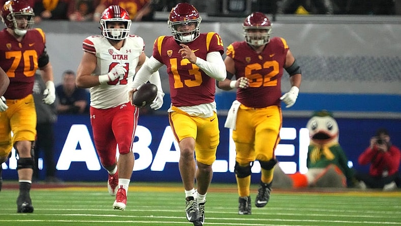Dec 2, 2022; Las Vegas, NV, USA; Southern California Trojans quarterback Caleb Williams (13) carries the ball against the Utah Utes in the second half of the Pac-12 Championship at Allegiant Stadium. Mandatory Credit: Kirby Lee-USA TODAY Sports