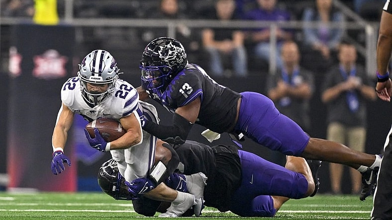 Dec 3, 2022; Arlington, TX, USA; Kansas State Wildcats running back Deuce Vaughn (22) is tackled by TCU Horned Frogs linebacker Dee Winters (13) during the second quarter at AT&T Stadium. Mandatory Credit: Jerome Miron-USA TODAY Sports